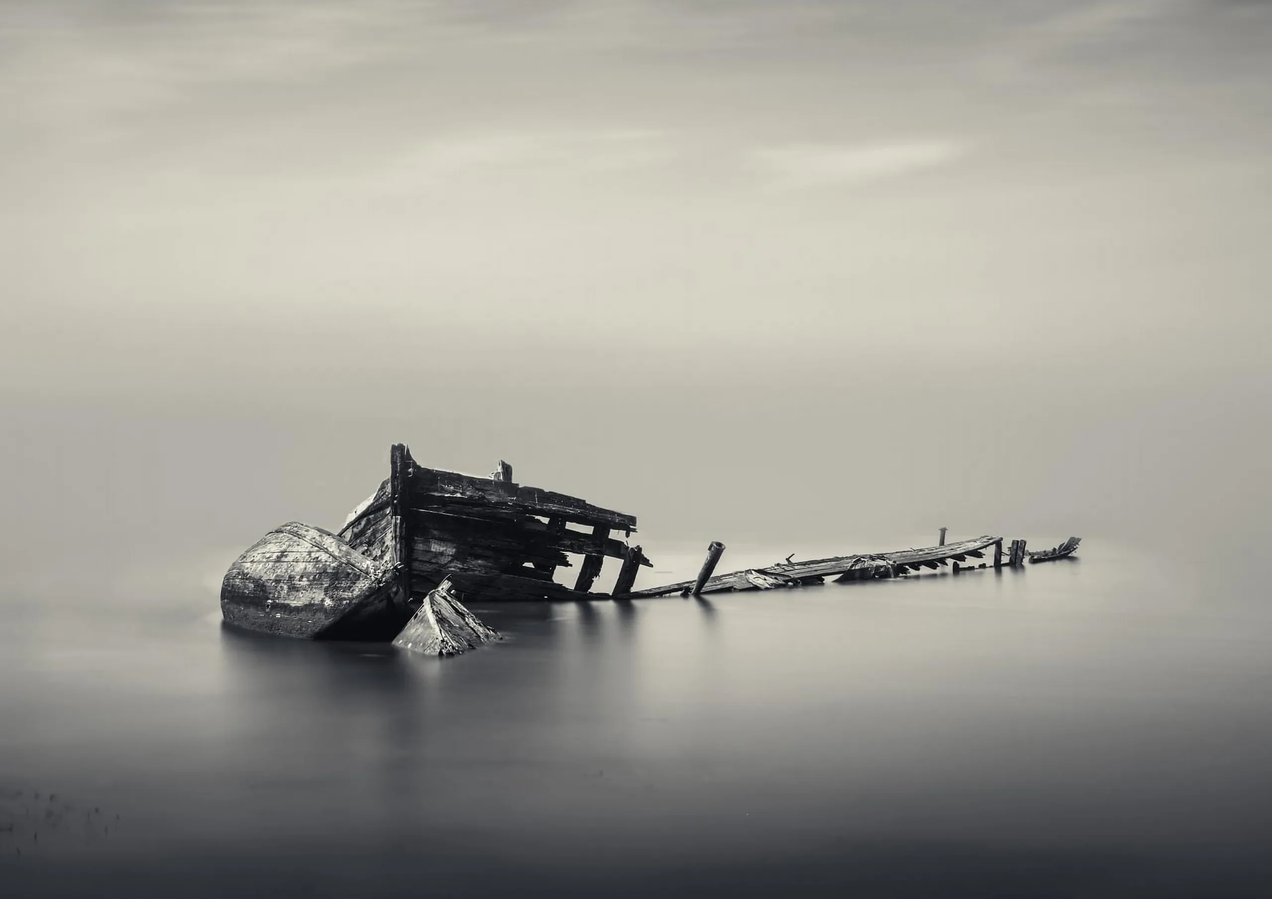 a boats remains in the middle of the sea