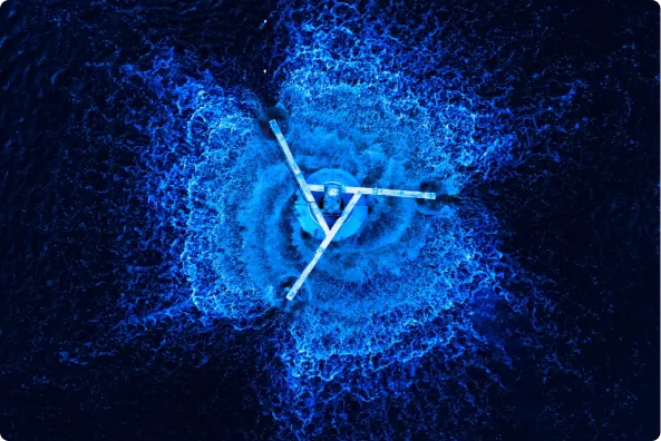 A blue structure in a symbolic shape in the middle of a body of water